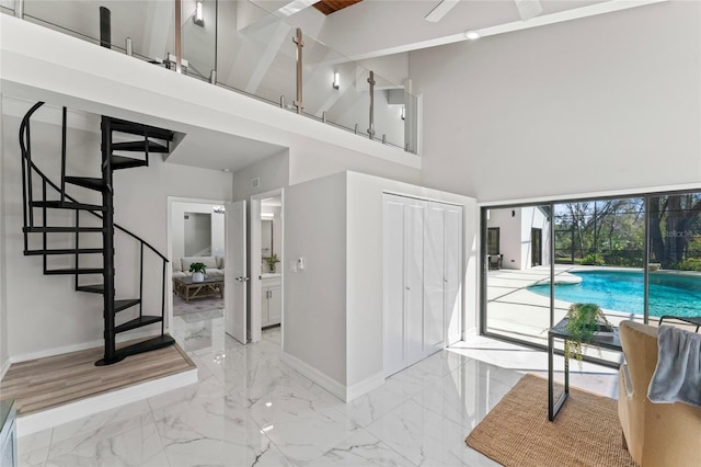 4520 Pine Hollow Dr, Tampa, FL 33624 - entrance foyer featuring baseboards, a towering ceiling, light marble finish flooring, and stairway