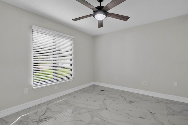 4520 Pine Hollow Dr, Tampa, FL 33624 - unfurnished room featuring light marble finish flooring, ceiling fan, and baseboards