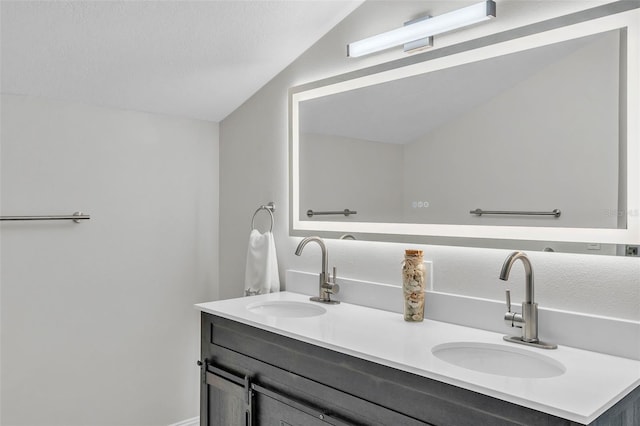 4520 Pine Hollow Dr, Tampa, FL 33624 - bathroom featuring double vanity and vaulted ceiling