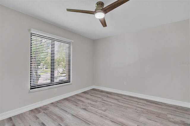 4520 Pine Hollow Dr, Tampa, FL 33624 - unfurnished room featuring light wood-style flooring, ceiling fan, and baseboards