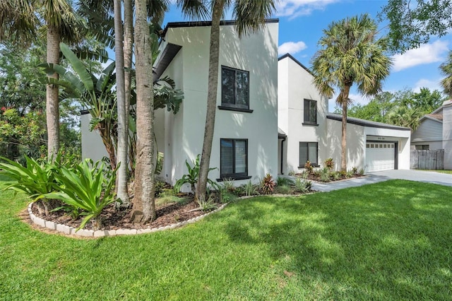 4520 Pine Hollow Dr, Tampa, FL 33624 - view of front facade with stucco siding, driveway, a garage, and a front lawn