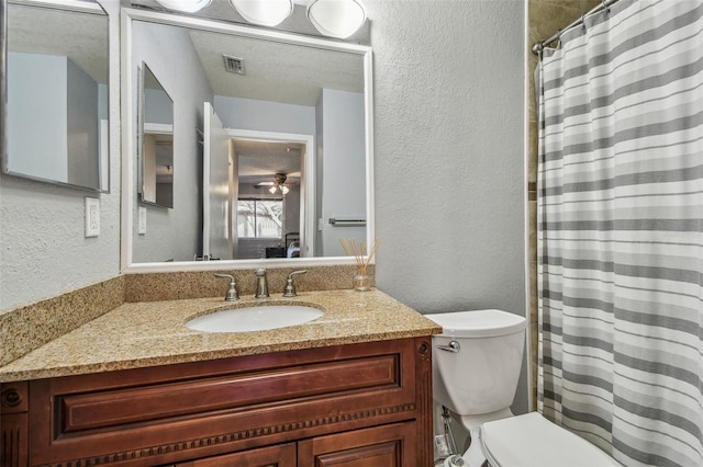 full bathroom with visible vents, a textured wall, toilet, curtained shower, and vanity