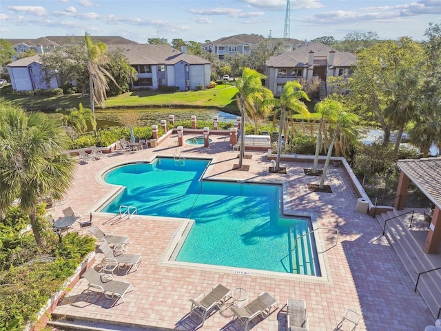 pool featuring a patio area and a residential view