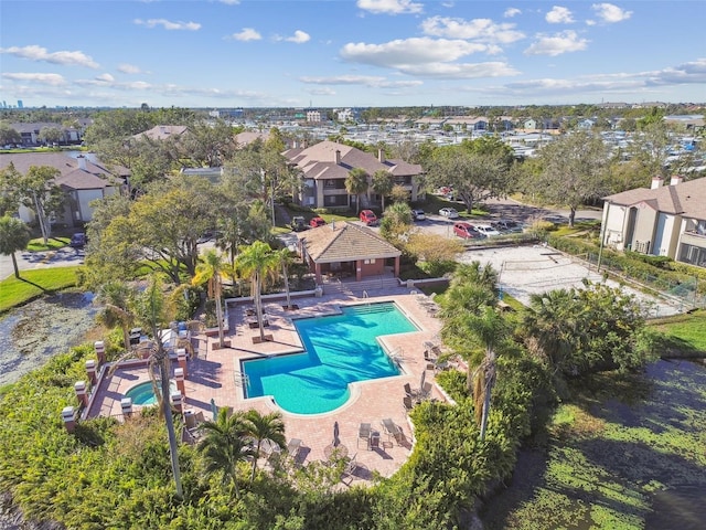 view of swimming pool featuring a residential view, fence, and a patio