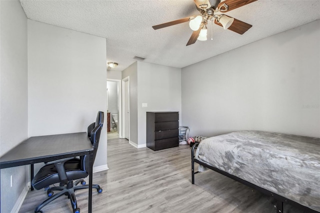 10263 Gandy Blvd N Unit 2014, Saint Petersburg, FL 33702 - bedroom featuring wood finished floors, visible vents, baseboards, a textured ceiling, and ceiling fan