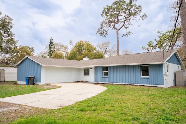 single story home with a garage, driveway, a chimney, and a front yard