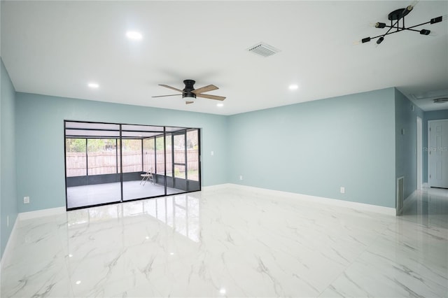 empty room with baseboards, marble finish floor, visible vents, and a ceiling fan