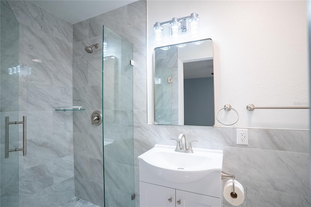full bath featuring a stall shower, tile walls, and vanity