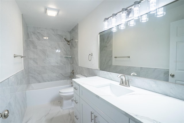 full bath featuring toilet, marble finish floor, bathtub / shower combination, vanity, and tile walls