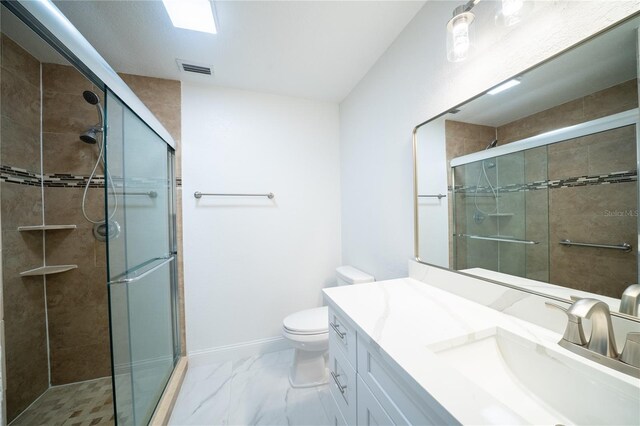 bathroom with marble finish floor, a shower stall, and toilet