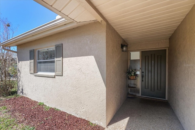 property entrance featuring stucco siding