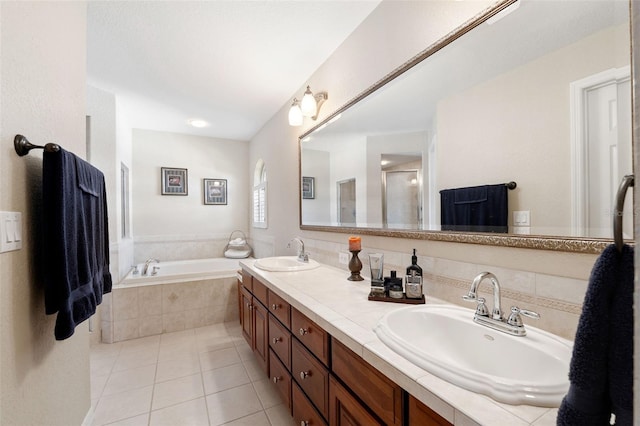 bathroom featuring tile patterned floors, double vanity, a sink, and a bath