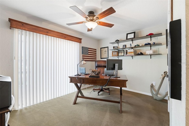 carpeted office space with ceiling fan