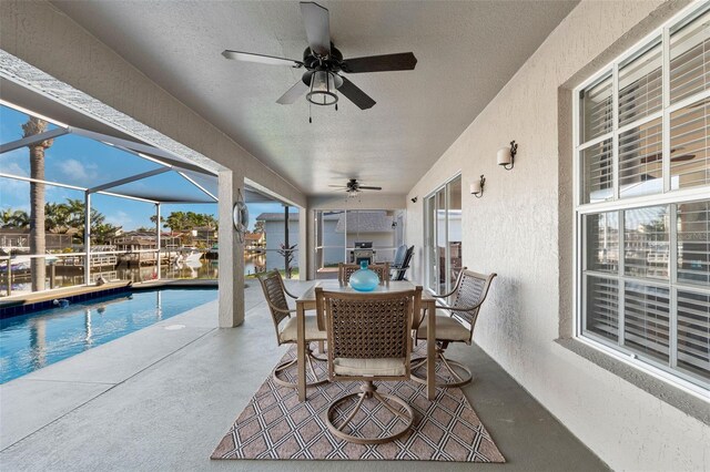 view of patio featuring an outdoor pool, a lanai, ceiling fan, and outdoor dining area