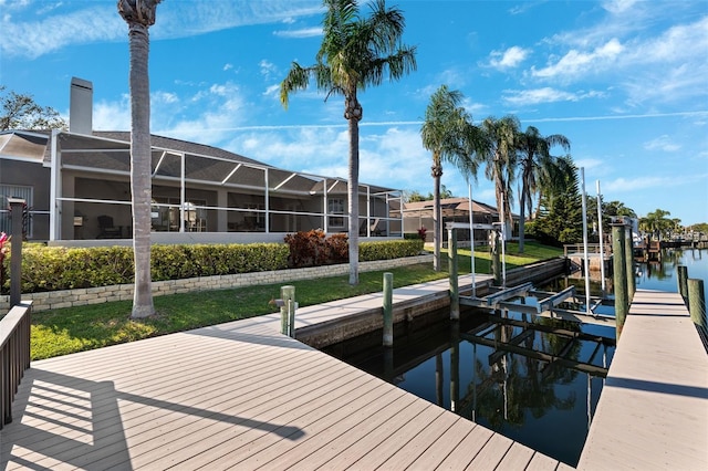 dock area with a lanai, a water view, and boat lift