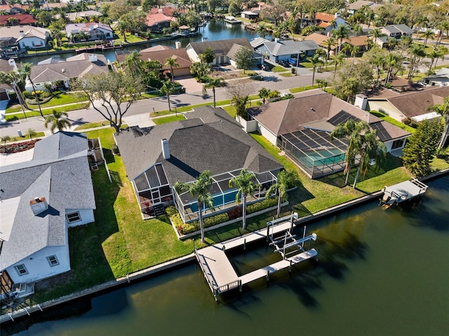 drone / aerial view featuring a residential view and a water view