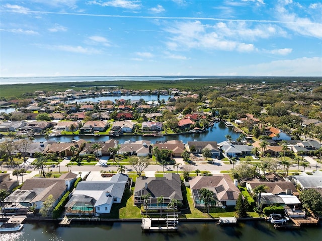 birds eye view of property featuring a water view and a residential view