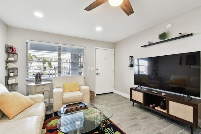 living area with recessed lighting, ceiling fan, and baseboards