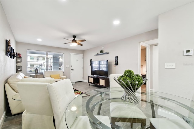 living area with a ceiling fan, recessed lighting, and baseboards