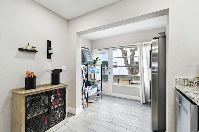 interior space with light wood finished floors and baseboards