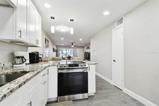 kitchen with a peninsula, stainless steel electric range oven, visible vents, and white cabinets