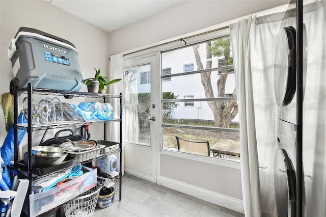 doorway featuring a sunroom and baseboards