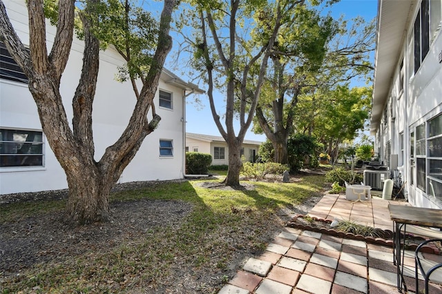 view of yard with a patio and central AC unit