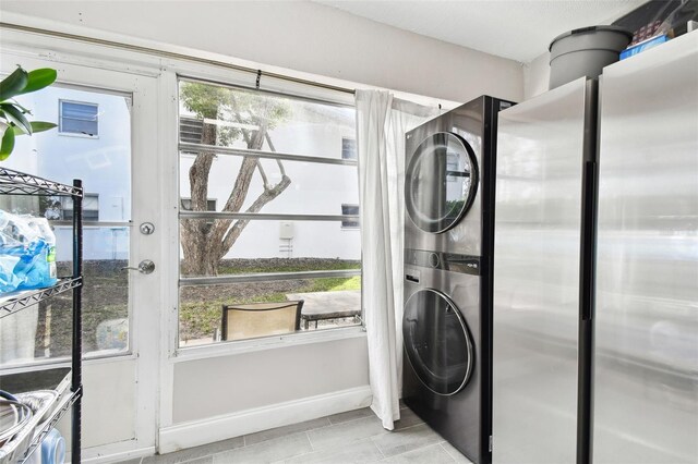 211 Brandy Wine Dr Unit 211, Largo, FL 33771 - laundry area featuring stacked washer / dryer and baseboards