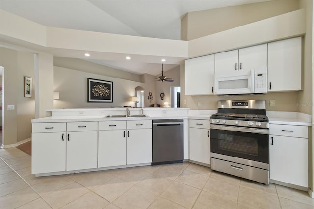 kitchen featuring appliances with stainless steel finishes, light countertops, a peninsula, and a sink