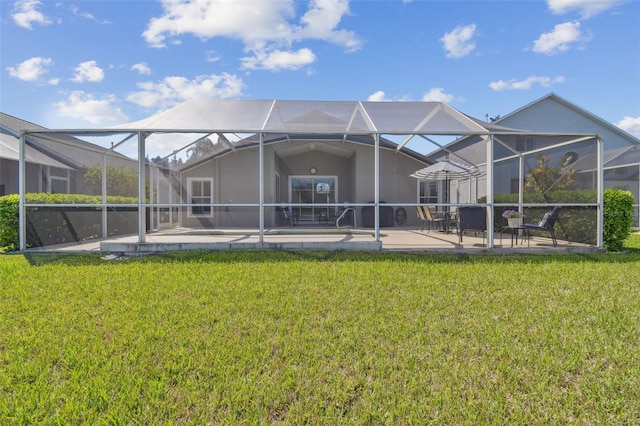 rear view of house with a yard, a lanai, and a patio