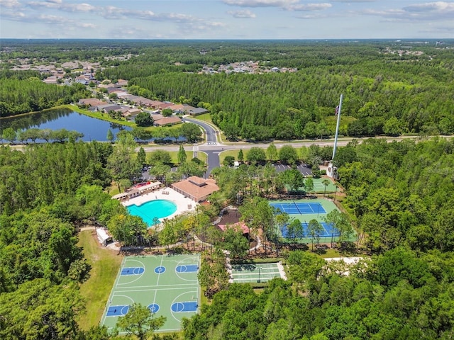 birds eye view of property with a forest view and a water view