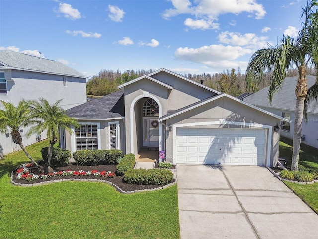 view of front of property featuring a shingled roof, a front lawn, stucco siding, driveway, and an attached garage