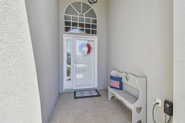 entrance to property with stucco siding