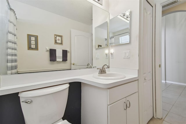 bathroom with tile patterned floors, visible vents, toilet, and vanity