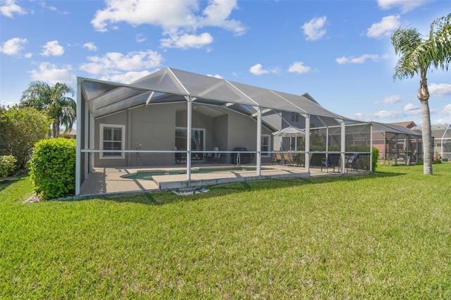 back of house with an outdoor pool, glass enclosure, a lawn, and a patio area