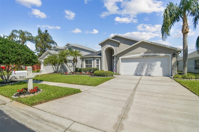 ranch-style home featuring stucco siding, an attached garage, driveway, and a front lawn