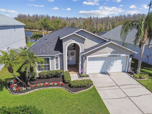 view of front of property featuring roof with shingles, driveway, stucco siding, a front lawn, and a garage