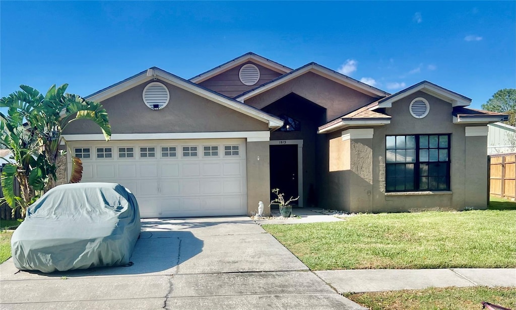 ranch-style home with a front yard, driveway, an attached garage, and stucco siding