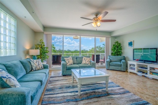 tiled living area with ceiling fan