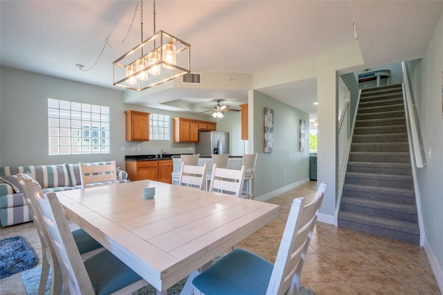 dining area featuring baseboards, visible vents, stairway, and a wealth of natural light