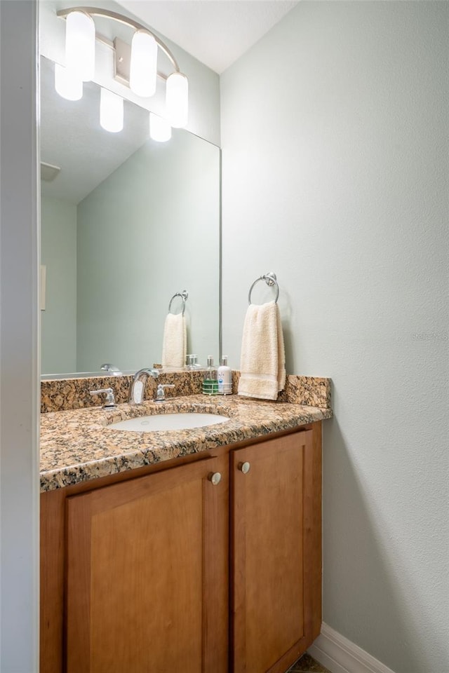 bathroom featuring baseboards and vanity