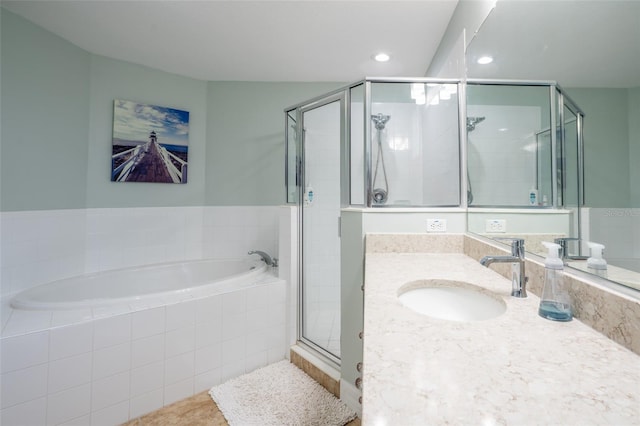 full bath with vanity, a shower stall, a bath, and recessed lighting