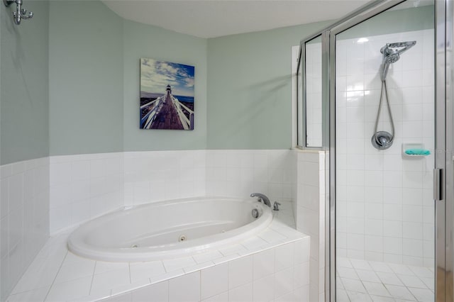 bathroom with a jetted tub and a shower stall