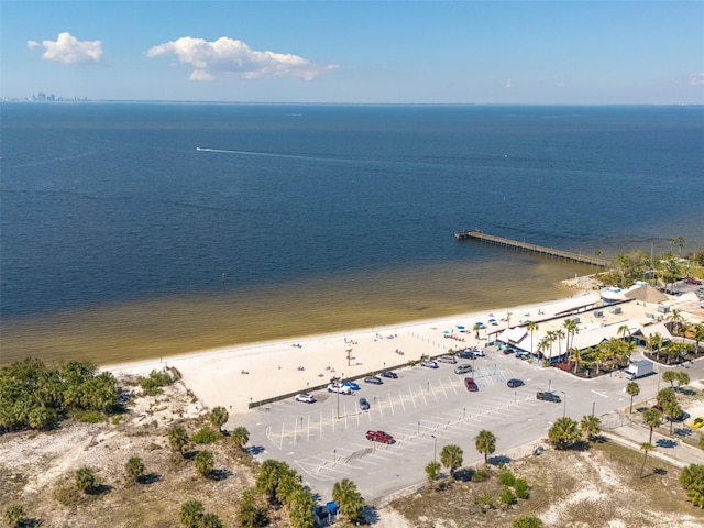 drone / aerial view featuring a water view and a beach view