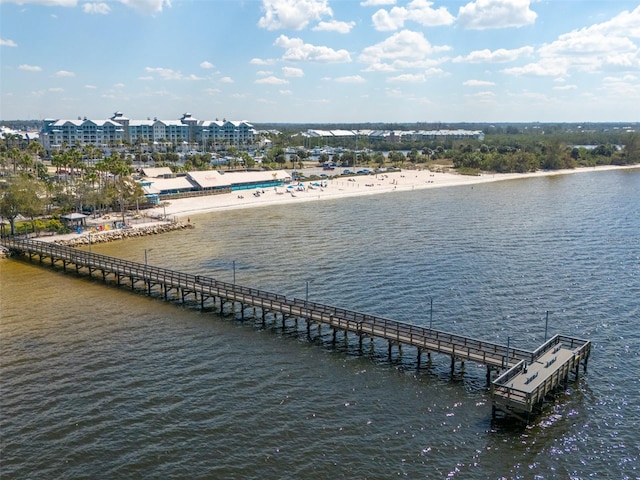 birds eye view of property with a water view and a view of the beach