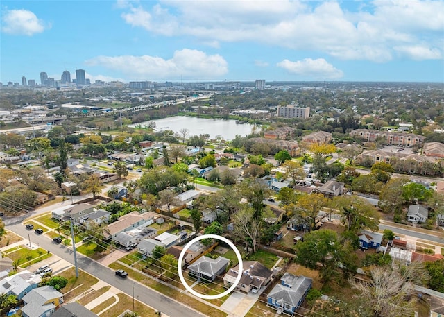 birds eye view of property with a water view and a city view