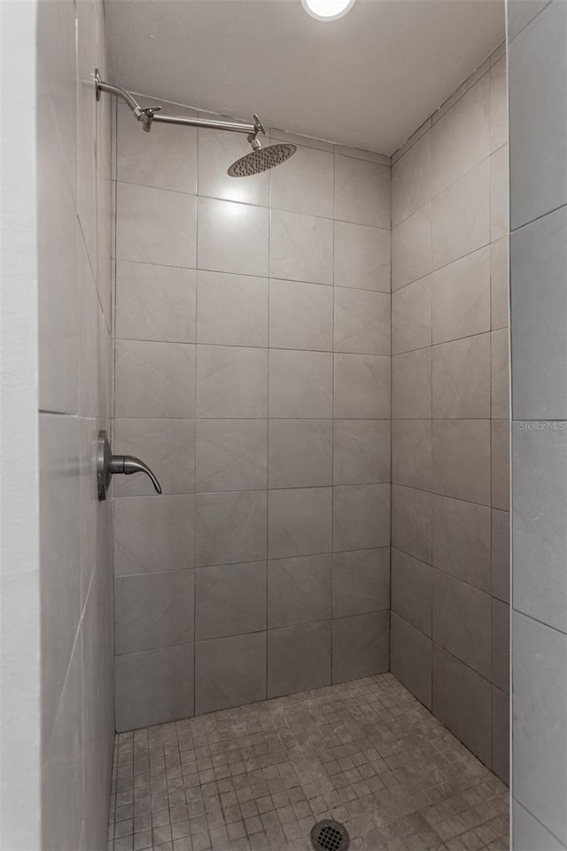 full bath with a tile shower