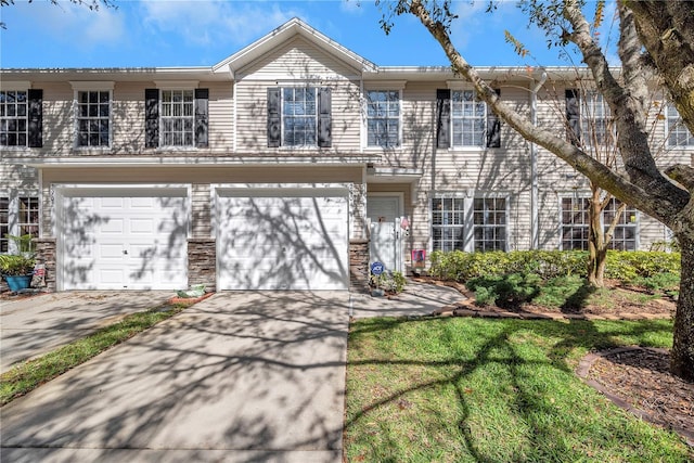 townhome / multi-family property featuring a garage and driveway