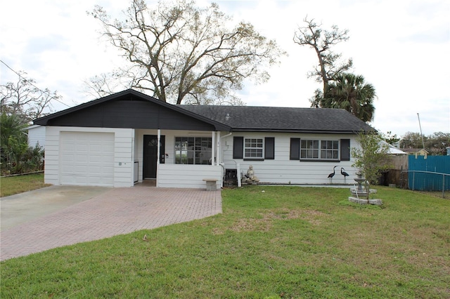 single story home featuring a garage, fence, a front lawn, and decorative driveway