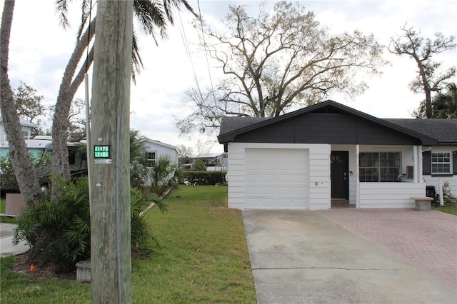 view of front facade featuring a front lawn, decorative driveway, and an attached garage